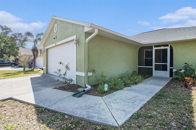 1601 14th St W, Palmetto, FL 34221 - view of home's exterior featuring stucco siding, a garage, driveway, and a sunroom
