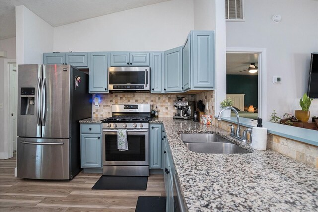 1601 14th St W, Palmetto, FL 34221 - kitchen featuring stainless steel appliances, a sink, lofted ceiling, tasteful backsplash, and ceiling fan