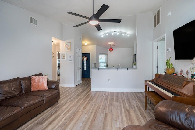 1601 14th St W, Palmetto, FL 34221 - living area featuring a ceiling fan, light wood finished floors, high vaulted ceiling, and baseboards