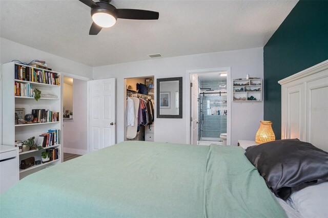 1601 14th St W, Palmetto, FL 34221 - bedroom with a walk in closet, a closet, ensuite bathroom, and a ceiling fan