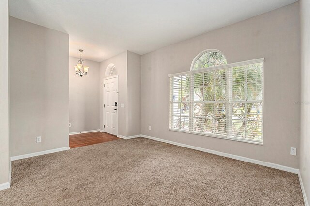 3219 Gianna Way, Land O Lakes, FL 34638 - spare room featuring dark colored carpet and a chandelier