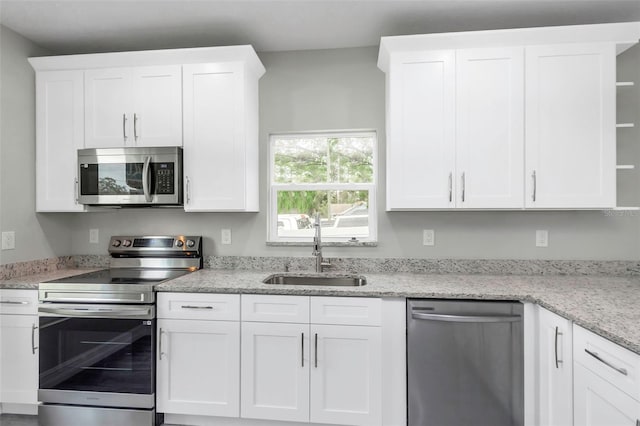 8505 N Brooks St, Tampa, FL 33604 - kitchen featuring stainless steel appliances, a sink, and white cabinets