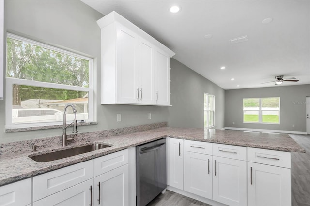 8505 N Brooks St, Tampa, FL 33604 - kitchen featuring stainless steel dishwasher, a sink, a peninsula, white cabinetry, and a ceiling fan