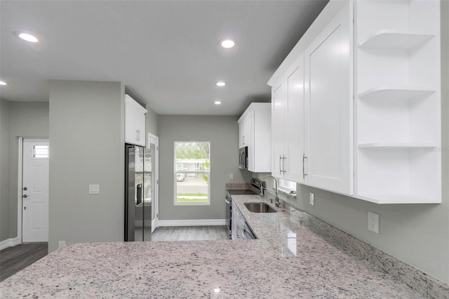 8505 N Brooks St, Tampa, FL 33604 - kitchen featuring stainless steel appliances, open shelves, a sink, wood finished floors, and recessed lighting