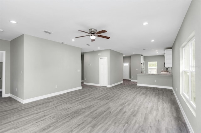 8505 N Brooks St, Tampa, FL 33604 - unfurnished living room featuring a ceiling fan, light wood-style flooring, recessed lighting, and baseboards