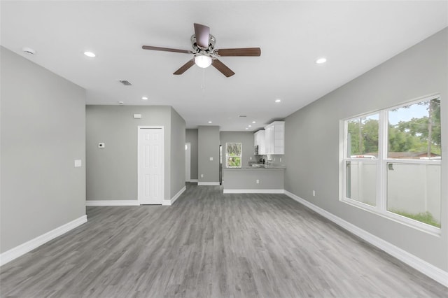 8505 N Brooks St, Tampa, FL 33604 - unfurnished living room featuring ceiling fan, light wood-style floors, baseboards, and recessed lighting