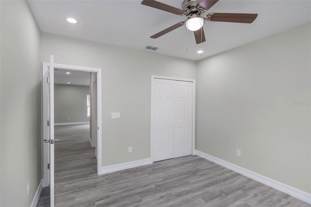 8505 N Brooks St, Tampa, FL 33604 - unfurnished bedroom with wood finished floors, baseboards, recessed lighting, a closet, and a ceiling fan