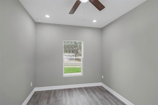 8505 N Brooks St, Tampa, FL 33604 - empty room featuring wood finished floors, baseboards, recessed lighting, ceiling fan, and a smoke detector