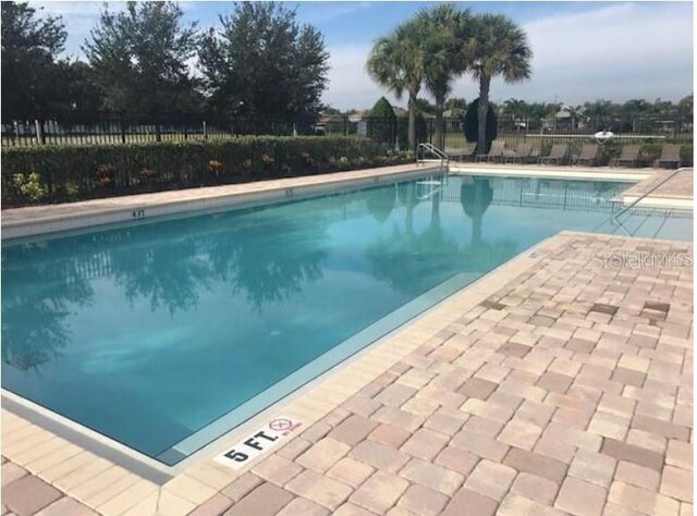 7029 White Treetop Pl, Riverview, FL 33578 - community pool featuring fence and a patio