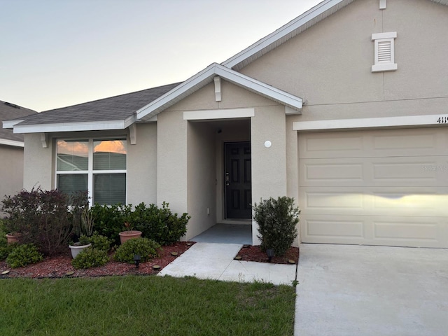 view of exterior entry with stucco siding