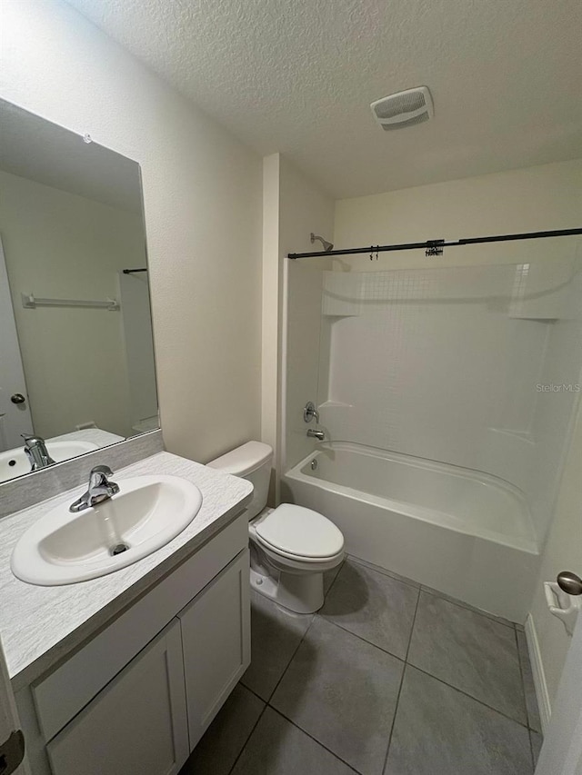 full bath with a textured ceiling, visible vents, toilet, vanity, and shower / bath combination