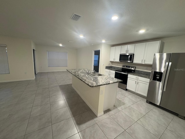 kitchen featuring light tile patterned flooring, a sink, visible vents, and appliances with stainless steel finishes