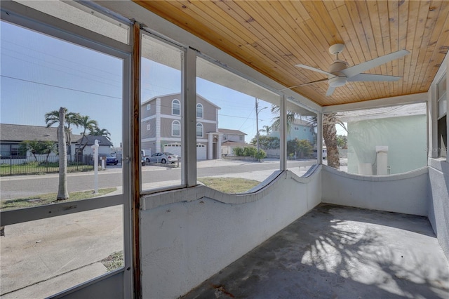 unfurnished sunroom featuring ceiling fan