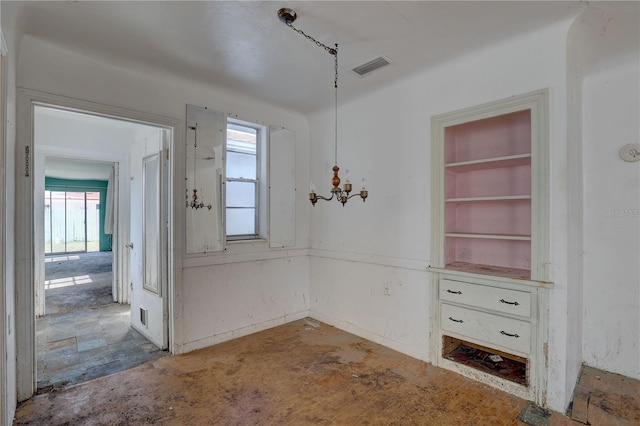 unfurnished dining area with visible vents and a chandelier
