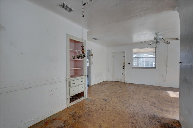 unfurnished room featuring visible vents and a ceiling fan