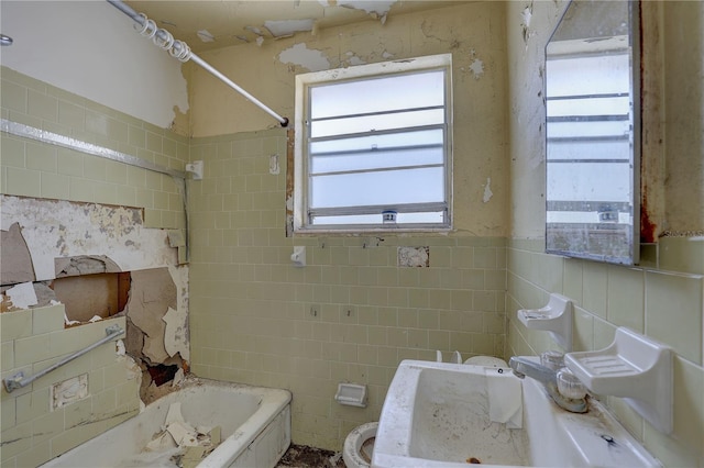 full bath featuring tile walls