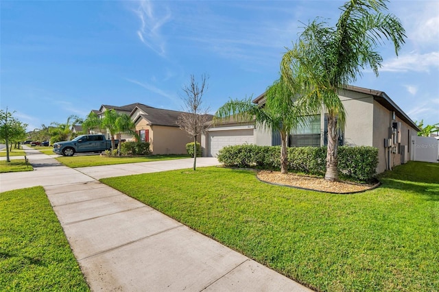 4201 Globe Thistle Dr, Tampa, FL 33619 - view of front of house with a front yard, an attached garage, concrete driveway, and stucco siding