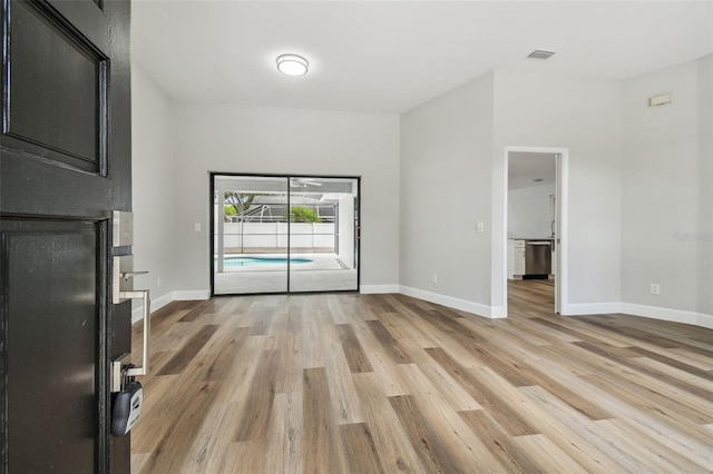 interior space with baseboards, visible vents, and light wood-style flooring