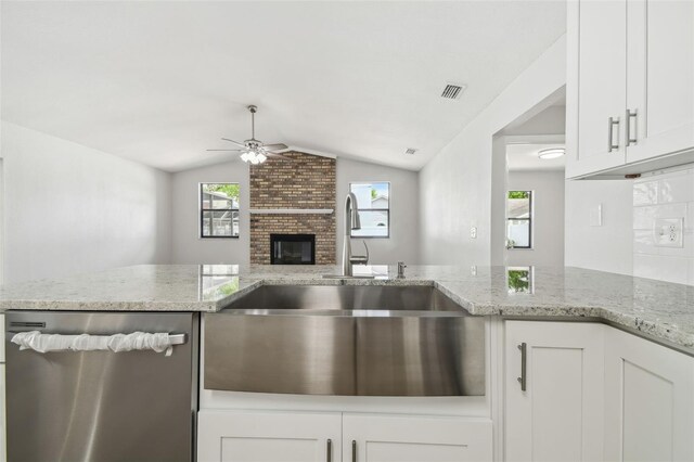 kitchen featuring a ceiling fan, dishwasher, open floor plan, lofted ceiling, and visible vents
