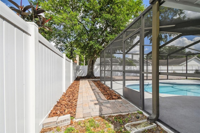 view of swimming pool with a fenced backyard, a lanai, a patio area, and a fenced in pool