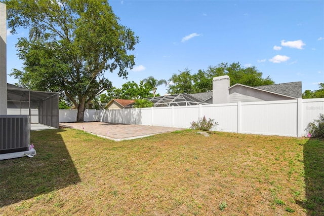 view of yard featuring central AC, a fenced backyard, and a patio area