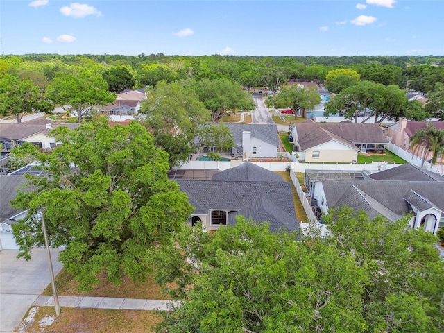 birds eye view of property with a forest view and a residential view