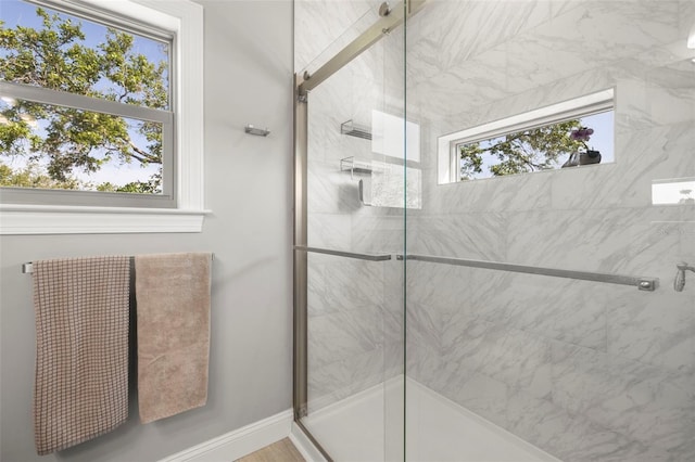full bathroom featuring baseboards and a stall shower