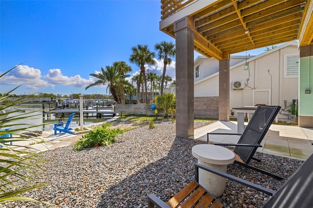 view of yard with a patio, fence, and a dock