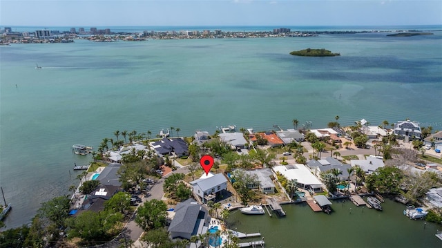 birds eye view of property with a water view and a residential view