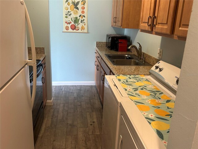 501 E Bay Dr Unit 2003, Largo, FL 33770 - kitchen featuring freestanding refrigerator, washer / clothes dryer, a sink, dark wood finished floors, and baseboards
