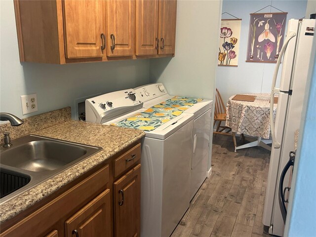 501 E Bay Dr Unit 2003, Largo, FL 33770 - laundry room featuring wood finished floors, cabinet space, and separate washer and dryer