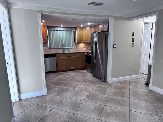 kitchen featuring visible vents, light tile patterned floors, a sink, and stainless steel appliances