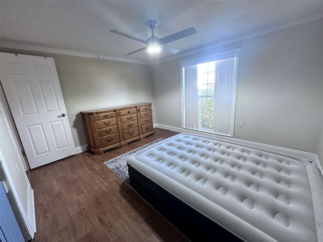 bedroom with ornamental molding, dark wood-type flooring, baseboards, a textured ceiling, and ceiling fan