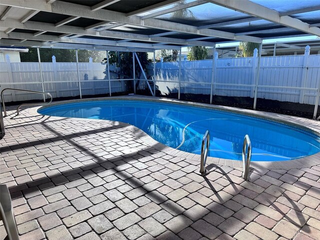 view of pool with a fenced backyard, a lanai, a patio, and a fenced in pool