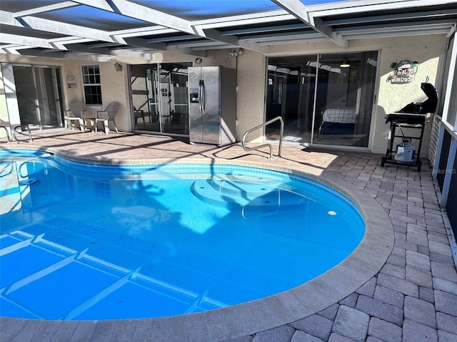 pool with a lanai and a patio area