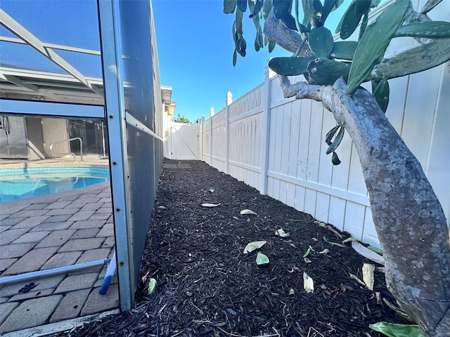 view of home's exterior featuring an outdoor pool, a fenced backyard, a lanai, and a patio area