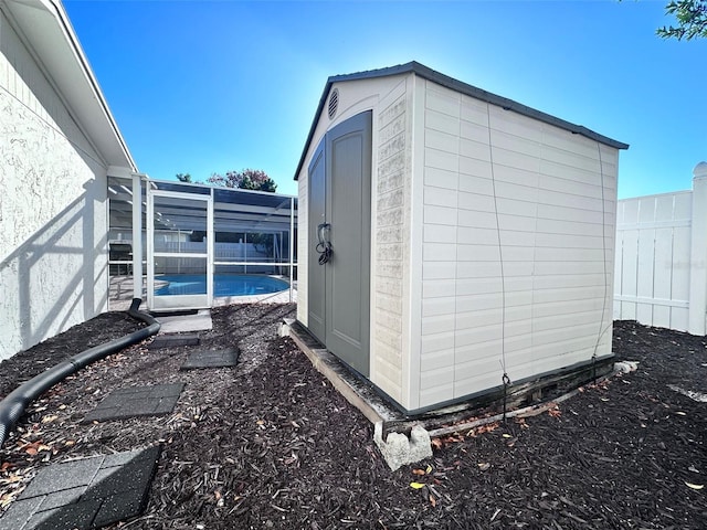 view of shed featuring a fenced backyard and an outdoor pool