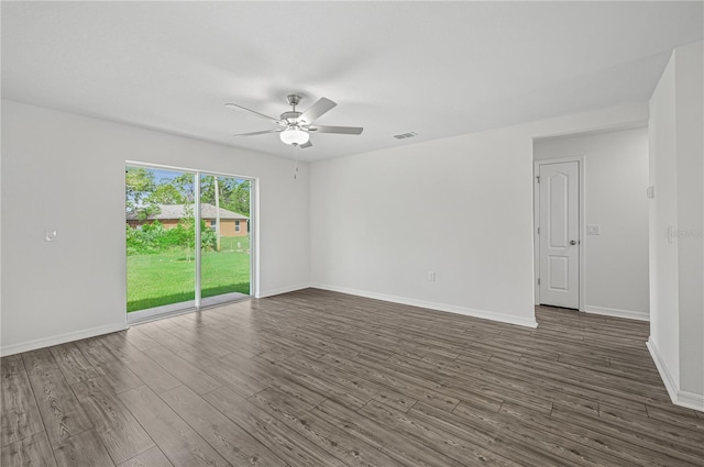 empty room with dark wood finished floors, baseboards, and a ceiling fan
