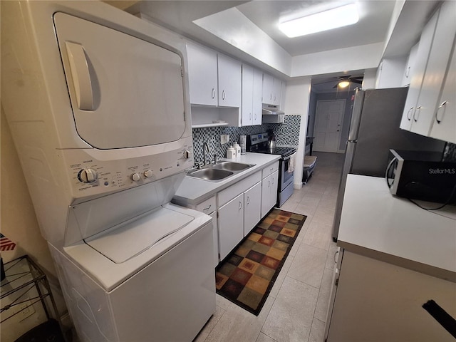 605 Brandy Wine Dr Unit 605, Largo, FL 33771 - kitchen with a sink, tasteful backsplash, stacked washer and clothes dryer, under cabinet range hood, and stainless steel electric range oven