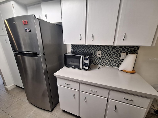 605 Brandy Wine Dr Unit 605, Largo, FL 33771 - kitchen featuring black microwave, light countertops, tasteful backsplash, and freestanding refrigerator