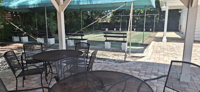605 Brandy Wine Dr Unit 605, Largo, FL 33771 - view of patio / terrace featuring outdoor dining area and shuffleboard