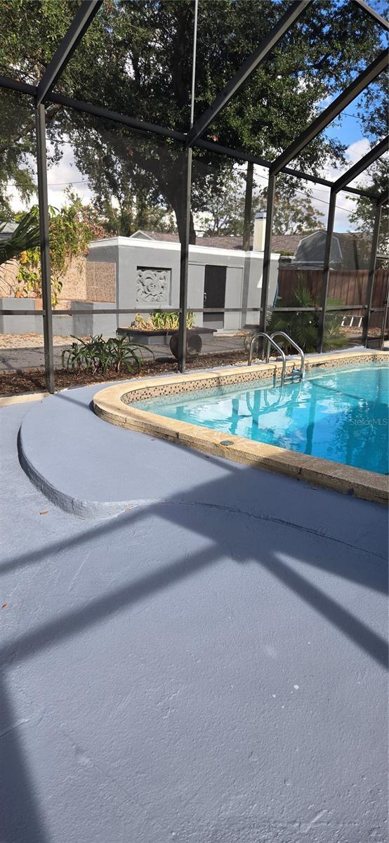 view of pool featuring a fenced in pool, glass enclosure, fence, and a patio