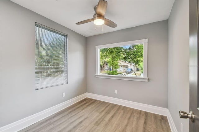 3411 N 12th St, Tampa, FL 33605 - spare room with baseboards, wood finished floors, and ceiling fan