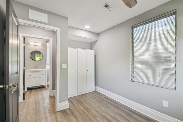 3411 N 12th St, Tampa, FL 33605 - unfurnished bedroom with baseboards, light wood finished floors, and visible vents