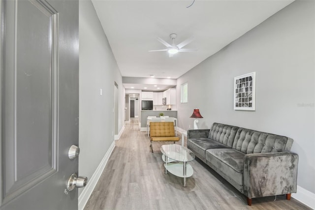 3411 N 12th St, Tampa, FL 33605 - living room featuring light wood finished floors, baseboards, and a ceiling fan