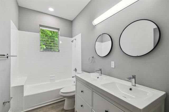 3411 N 12th St, Tampa, FL 33605 - full bathroom with toilet, a sink, wood finished floors, and shower / washtub combination