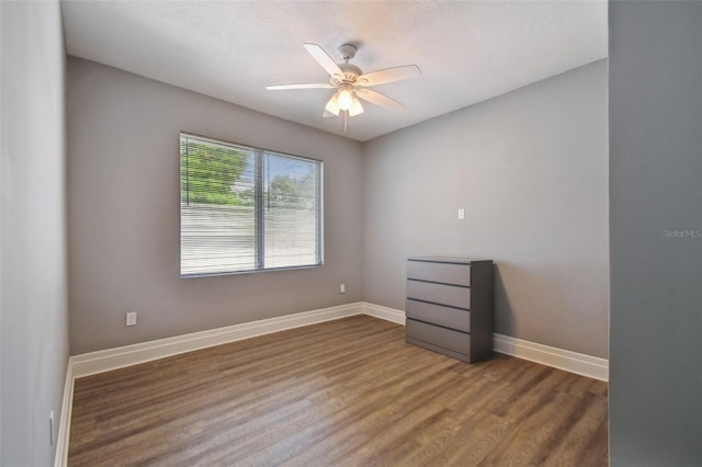 3411 N 12th St, Tampa, FL 33605 - unfurnished room with baseboards, wood finished floors, and a ceiling fan