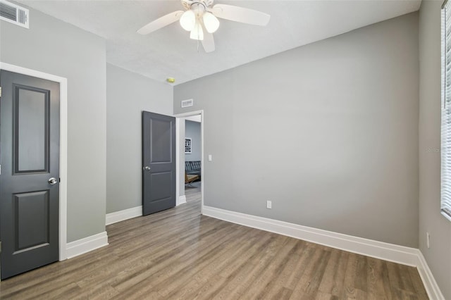 3411 N 12th St, Tampa, FL 33605 - empty room featuring baseboards, visible vents, wood finished floors, and ceiling fan