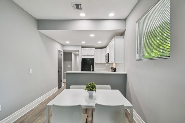 3411 N 12th St, Tampa, FL 33605 - dining area featuring recessed lighting, visible vents, baseboards, and wood finished floors