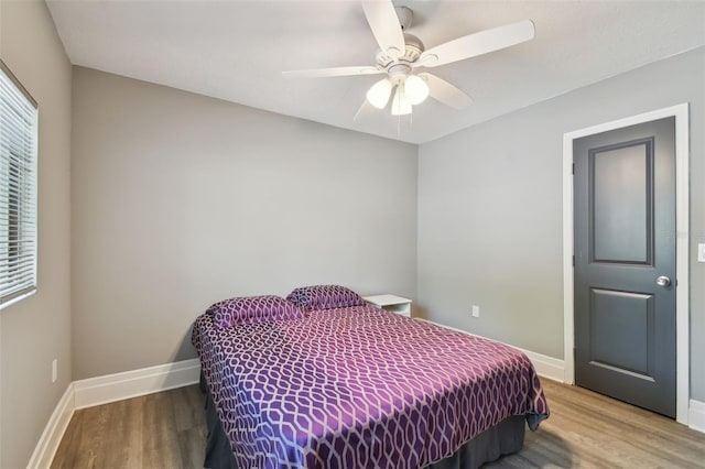 3411 N 12th St, Tampa, FL 33605 - bedroom with multiple windows, baseboards, and wood finished floors